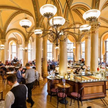 Vienna-coffeehouses-Cafe-Central-Photo-credit-Flikr-a.canvas.of_.light_-1180x787-1.jpg Cafenelele istorice din Viena păstrează ziarele tipărite pe mesele clienților. Unele localuri oferă gratuit până la cincisprezece publicații diferite zilnic